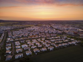 Dawn behind the Riedberg district of Frankfurt heralds the imminent sunrise. (Aerial view with a