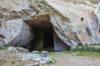 Rope grotto, Large opening to a cave in a rocky landscape surrounded by grass, Neapolis