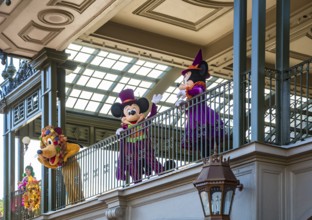 Mickey Mouse, Minnie Mouse, and Pluto welcome guests to the Magic Kingdom at Walt Disney World,