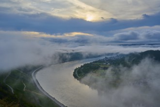 A river winds through misty mountains while the sun illuminates the sky, summer, Rhine bend