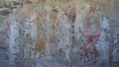 Faded frescoes on ancient wall with figures and paint remains, Archaeological Site, House of Beluga