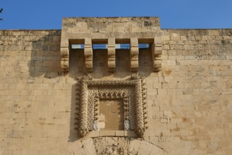 Detailed view of an old wall with architectural decorations under a blue sky, Ortigia Island, Isola