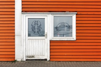Colourful lobster shack, orange wooden façade with door and window, lobster pictogram, façade