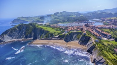 Breathtaking aerial perspective of zumaia's dramatic cliffs, golden beaches, and charming town