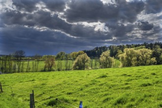 Rising rain clouds in a spring landscape, Franconia, Bavaria, Germany, Europe