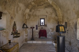 Small chapel interior with icons and religious decorations on the wall, Agios Nikolaos Chapel,