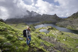 Mountaineer on hiking trail, view of mountain landscape with mountain lakes Wangenitzsee and