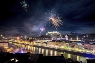 Colorful firework in the night: Old city of Salzburg and Festung Hohensalzburg at New Year?s Eve.