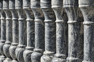 Beautiful gray marble balustrade illuminated by the bright sun. Stone background