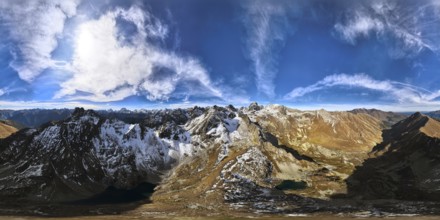 Panoramic shot of a mountain range in summer on a sunny cloudless day. bare rocky cliffs