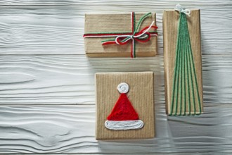 Handmade Christmas gift boxes on wooden board Celebration concept