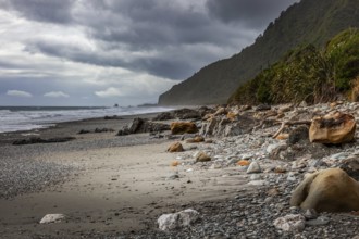 Stormy weather approaching a rock strewn beach in New Zealand