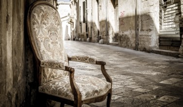 Lecce town, Italy. Vintage chair with old town street in background