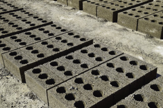 Freshly made cinder blocks on a concrete pad