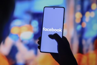 In this photo illustration, the Facebook logo is displayed on a smartphone screen