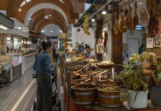 Cork, Ireland, 16 August, 2022: customers buying food at a market stall with Spanish delicacies and