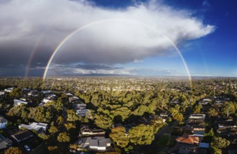 A winter's day storm and rainbow aerial view over the estate of Springthorpe near Bundoora in
