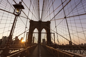 Brooklyn Bridge sunset with Manhattan skyline of New York City USA