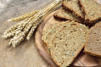 Cereal, wheat and bread on a wooden table. Different types of bread on wood