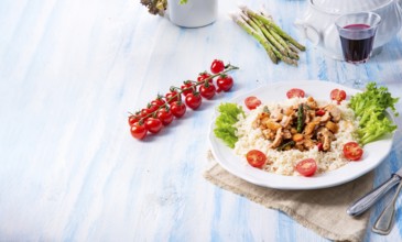 Turkey fricassee on rice with asparagus and peppers