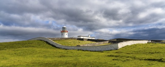A view of the historic harbor lighthouse at St. John's Point in Donegal Bay in the north of Ireland