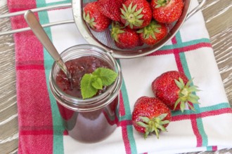 Homemade strawberry jam with fresh fruits in a sieve Home made strawberry jam with fresh fruits in