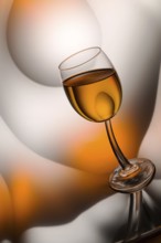 Glass of cognac in a distorted reflection