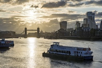 View over the Thames with Tower Bridge and the skyline in the evening light, London, England, Great
