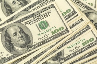 Many American dollar banknotes. Symbolic photo for debt and wealth Austria