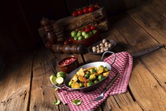 Brussels sprouts potato pan with bacon in a rustic style