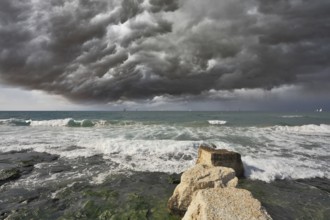 Severe storm cloud over the surf. Mediterranean Sea, Israel, Asia