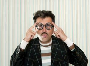 Nerd silly myopic man with glasses thinking doing funny gesture with retro mustache