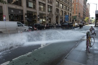 Spray of water from broken johnny pump on Manhattan, New York, USA, North America
