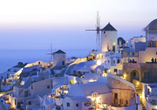 Iconic view of Oia village Santorini with windmills at sunset, Greece, Europe