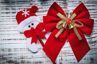 Santa Claus toy red bow on vintage wooden board celebrations concept