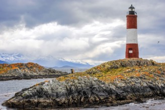 Les Eclaireurs lighthouse against a dramatic sky and snowy peaks in Argentina
