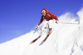 Skiers in action, descent on a slope, deep snow