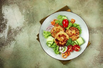 Fried chicken cutlets, minced chicken, with vegetables, on a green background, with vegetable