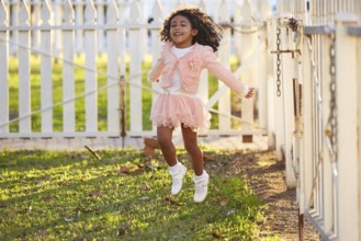 Kid girl toddler playing jumping in park outdoor latin ethnicity