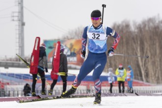 Korean sportsman biathlete Yang Seon Jik skiing on snow distance biathlon stadium during Junior