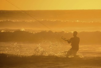 Single surfer at sunset on a calm ocean