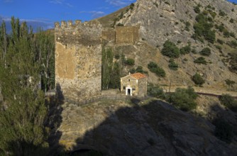 Medieval tower and old Christian temple near the ruins of the Genoese fortress in Sudak, Crimea