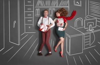 Happy valentines love story concept of an office romance. Young couple at work smiling at each