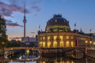 The Bode Museum in Berlin in front of sunrise with the famous television tower in the background