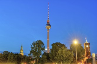 The famous television tower with the towers of St Mary's Church and the town hall in Berlin at