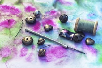 Beads and tools for needlework on bright background