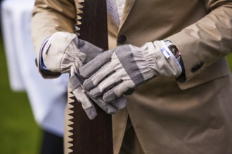 Man wearing gloves and holding saw
