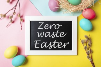 Zero waste Easter concept. Colorful eggs and pussy willow branches on bright colorful background
