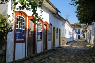 Typical cobblestone street with colorful colonial buildings in the late afternoon sun and shadows