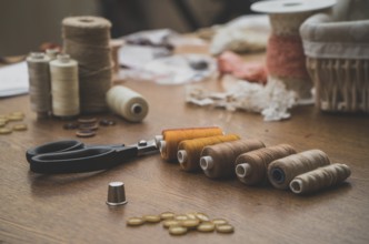 Sewing concept. Scissors, threads and buttons